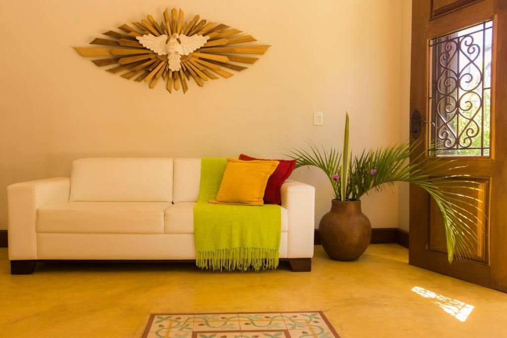 Sala de estar com sofá branco e porta de madeira